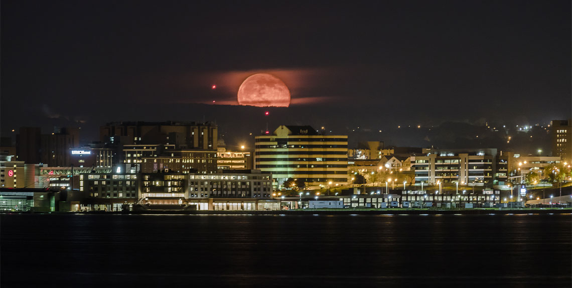 Moon visible above the Erie, PA skyline